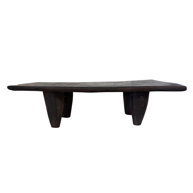 Hand-carved from a single piece of solid dark brown wood, this authentic Senufo stool from Côte d'Ivoire showcases the...