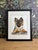 This original watercolor painting features a German shepherd puppy captured in a quiet, endearing moment of curiosity and...