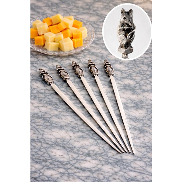 A charming set of vintage silverplate cocktail picks featuring sculptural figural mice (with cheese) finials, designed for...
