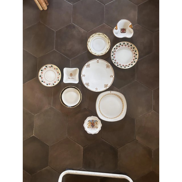 Elegant and regal, this red., white, and gold coat of arms motif wall plate curation will add a touch of art deco glamour...