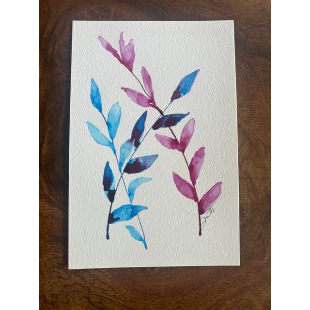 Two elegant branches painted in cool indigo and warm rose tones. Clean negative space and confident leaf shapes give this...
