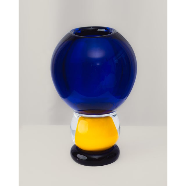 Murano glass vase. Made using traditional Venetian techniques, with a globular blue body, a yellow stem, and clear glass;...