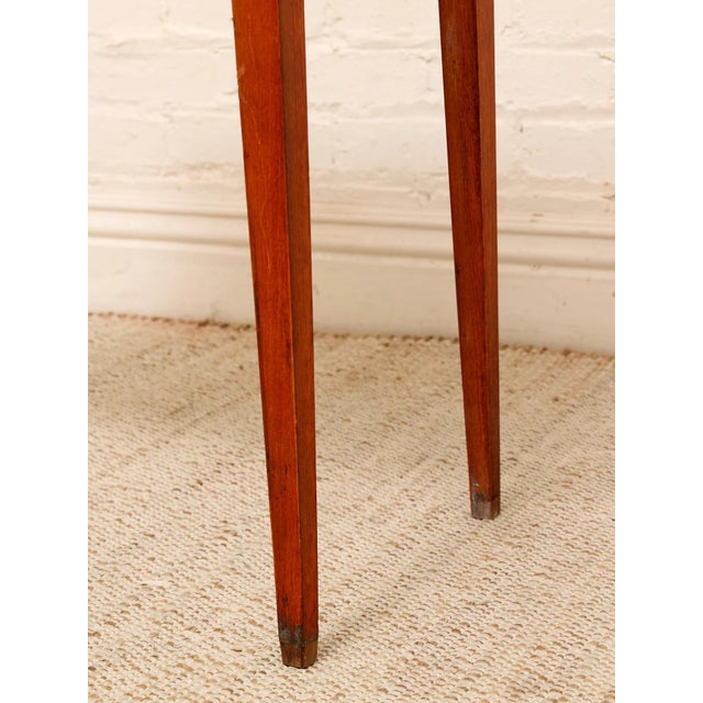 An elegant vintage console table with a warm mahogany-toned finish and a wonderfully delicate silhouette. The shaped...