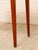 An elegant vintage console table with a warm mahogany-toned finish and a wonderfully delicate silhouette. The shaped...