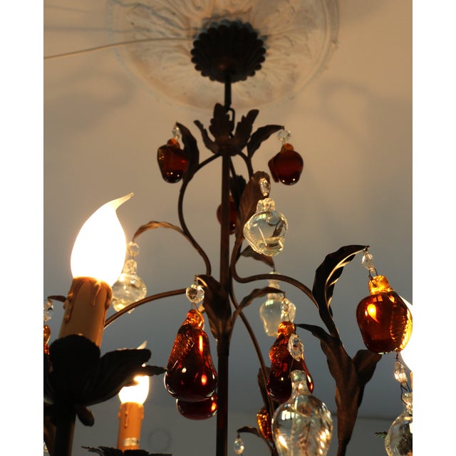 Classic-style wrought iron and Murano glass pendant chandelier featuring an ornamental frame with plant motifs and...