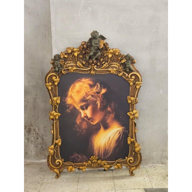 A spectacular French Rococostyle decorative portrait frame, richly sculpted with elaborate scrollwork, floral vines,...