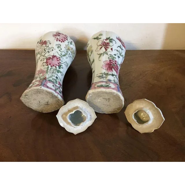 Pair early 18th century Chinese export porcelain famille rose garniture vases and covers. Decorated with peonies and...