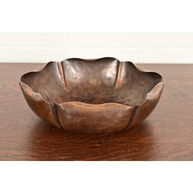 A gorgeous Arts & Crafts hand hammered copper flower form fruit bowl or center bowl with ruffled edges In the manner of...