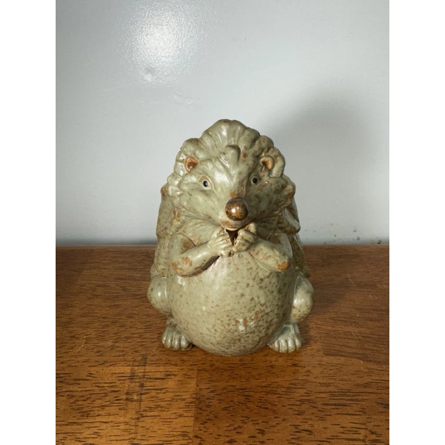 Ceramic hedgehog figurine with a cute, detailed design. Charming animal statue perfect for shelf display, home décor, or...
