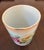 Charming vintage porcelain cachepot or small decorative vessel with matching plate featuring lush pink and creamy yellow...