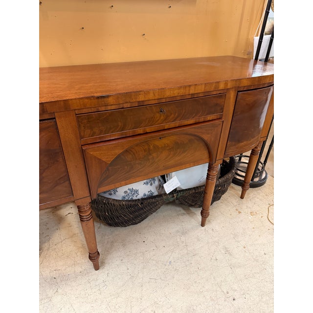 1900 - 1909 Regency/Federal Figured Mahogany Sideboard With Bowed Ends, Turned Legs, and the Distinctive Arched Center Panel. For Sale - Image 4 of 12