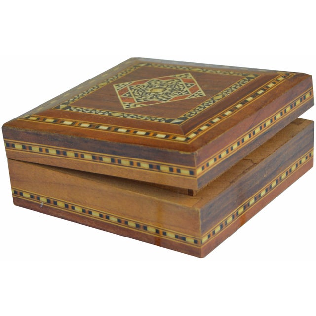 Handcrafted box with mother-of-pearl inlay featuring an intricate display of fibulas for protection, astral symbols, and...
