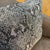 The cover carries a large-scale python snakeskin pattern across its full face, the oversized diamond-shaped scale motif...