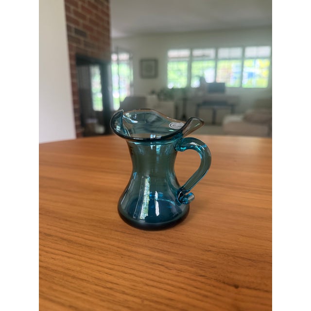 A little piece of West Virginia sky on your shelf. This sweet hand-blown mini pitcher — or creamer — comes from the...