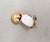1960s goldtone white cabochon belly with small round faux-garnet eye chick or bird brooch with security clasp. Marked...