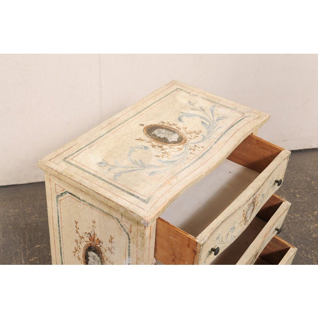 An Italian Neoclassical style, small-sized, hand-painted serpentine chest, from the mid 20th century. This vintage chest...