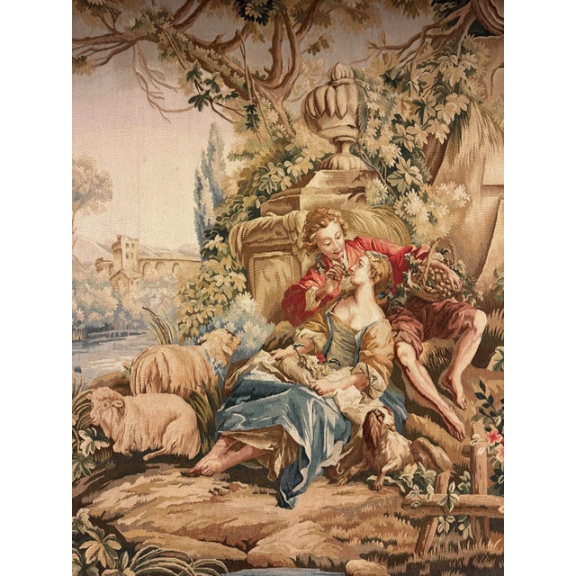 This vintage tapestry dates to the 1980s and features a romantic pastoral scene inspired by classical French countryside...