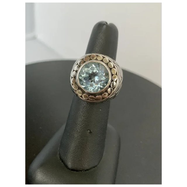 Blue topaz crowns the powerful design of this cocktail ring. Sterling silver and featuring modern stylizations, make this...