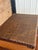A wonderfully charming vintage decorative suitcase trunk featuring woven rattan panels, warm wood construction, brass-tone...