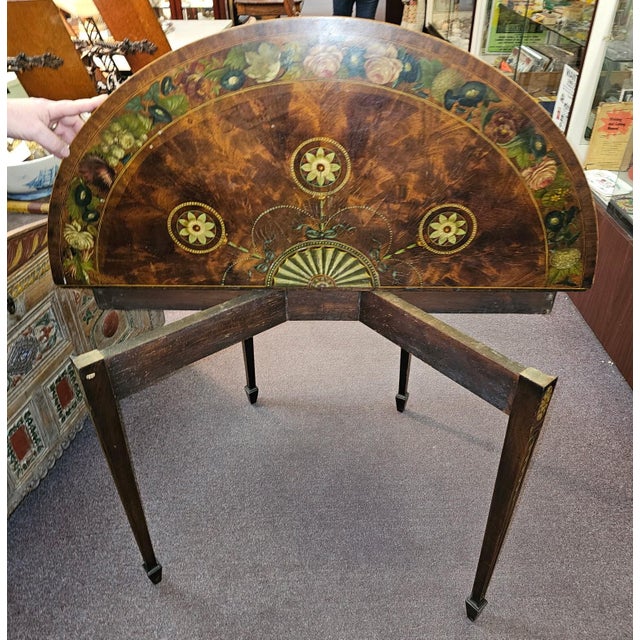 Beautifully Crafted late 18th century hand painted demi lune game table with finely detailed floral and swag motif. On...