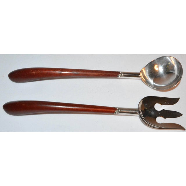 A very nice set, circa 1950s sterling silver and wood salad serving set by a Mexican silversmith is up for your...