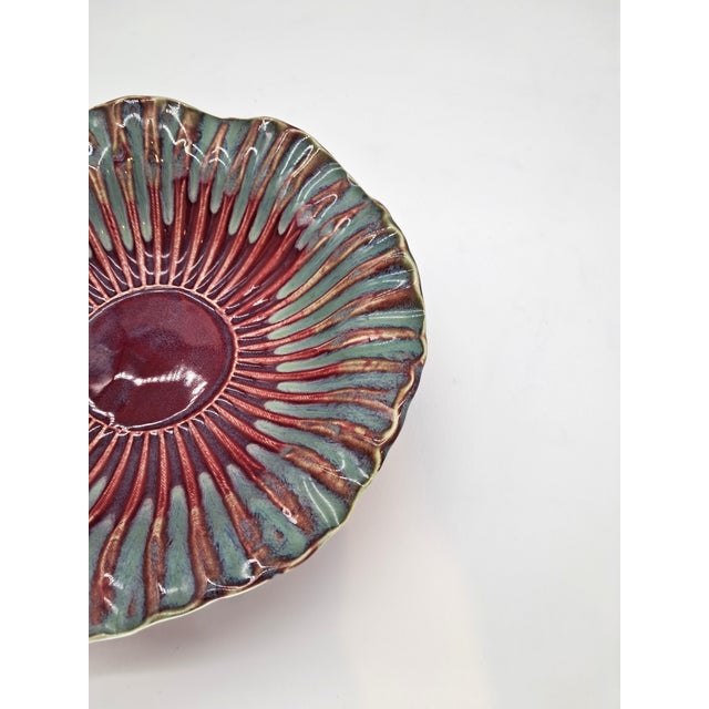This gorgeous ruffled pottery bowl features a burgundy base with a teal glaze. The scalloping is textured, which adds...