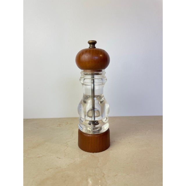 Vintage mid-century pepper mill by Peugeot, featuring a sculptural clear Lucite/acrylic body that showcases the...