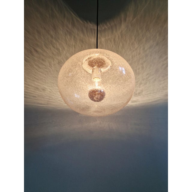 Space Age pendant light in clear bubble glass with a chrome-plated metal frame, dating from the 1960s-70s. It has been...