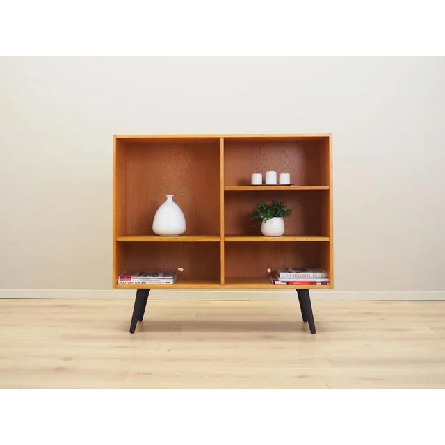 The bookcase was made in the 1970s, Danish production. The structure is covered with ash veneer, the top covered with...