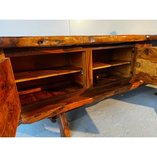 A unique, sculptural sideboard in solid olive wood by Maison Skela, dating from the 1960s in the style of Alexandre Noll....