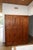 A handsome early 20th century four-door pine wardrobe with the unmistakable character of a European vestiaire — the...