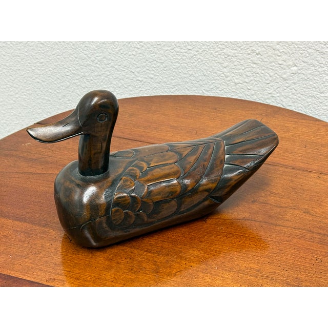 Design Plus Gallery presents a Folk Art Hand Carved Wooden Duck. The sculptural form has a deep brown stained surface,...