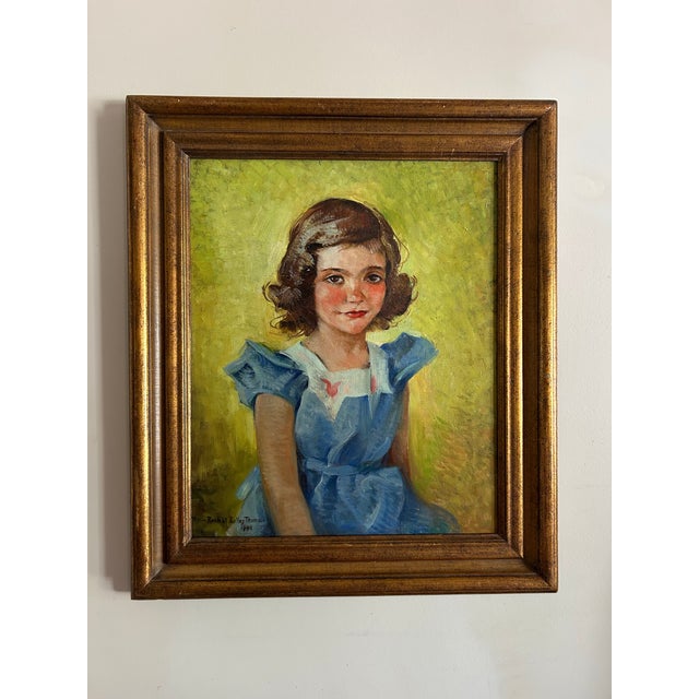Early 20th century, 1940, framed portrait of a young girl in a blue dress. Signed ‘Rachel Bulley Trump’, dated 1940, to...