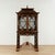Standout vintage black and gold Chinese Chippendale style cabinet, handcrafted in hardwood with a dramatic pagoda top. The...