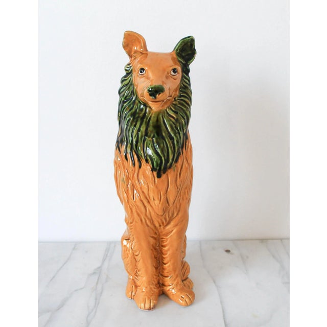 Vintage golden and green ceramic dog figurine. No makers mark. Two chips on ear.