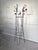 An iconic example of French Mid-Century design, featuring a black lacquered steel wire structure adorned with brightly...