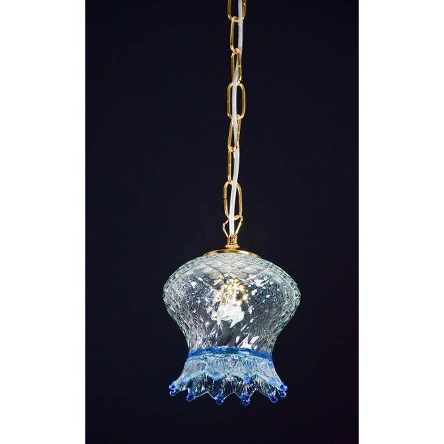 Set of 3 blue and transparent Murano glass pendants. The 3 pendants are formed by the glass and the chain in new gold...