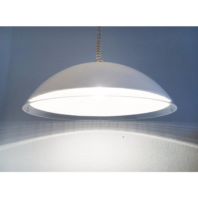 Impressive pendant light by the Italian manufacturer iGuzzini based on a design by Franco Bresciani. The flat lampshade...