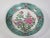 A Japanese bowl hand painted in Hong Kong. It is decorated with a floral center and a floral and scroll boarder, painted...