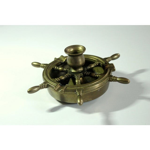 Solid brass ashtray in the shape of a steering wheel with a candle stick, in excellent vintage condition diameter with...