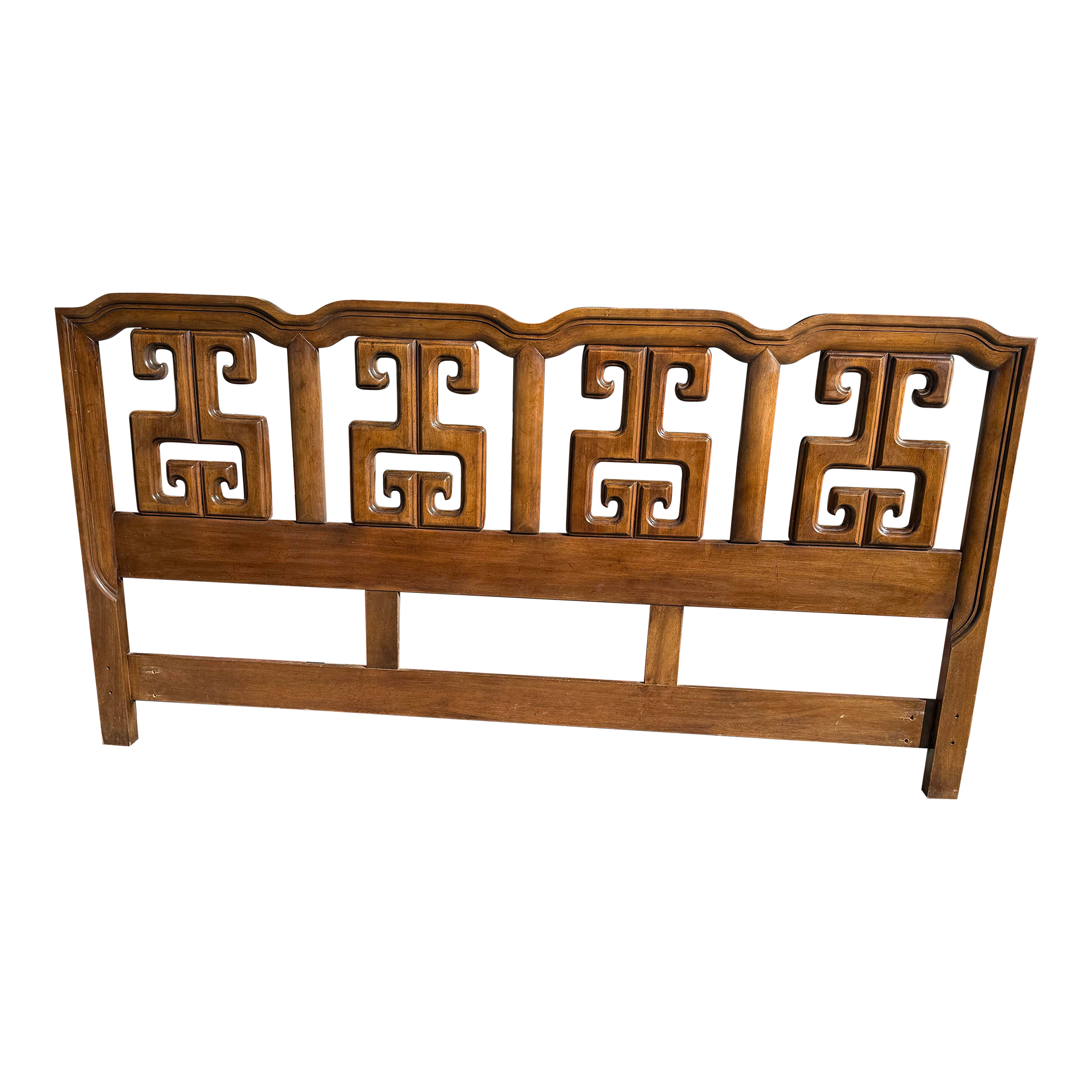 Wooden headboard with intricate carved fretwork on a plain white background.
