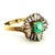 An elegant circa 1980 ballerina ring crafted in 14K yellow gold, centered by a 0.88 carat rectangular step-cut emerald....