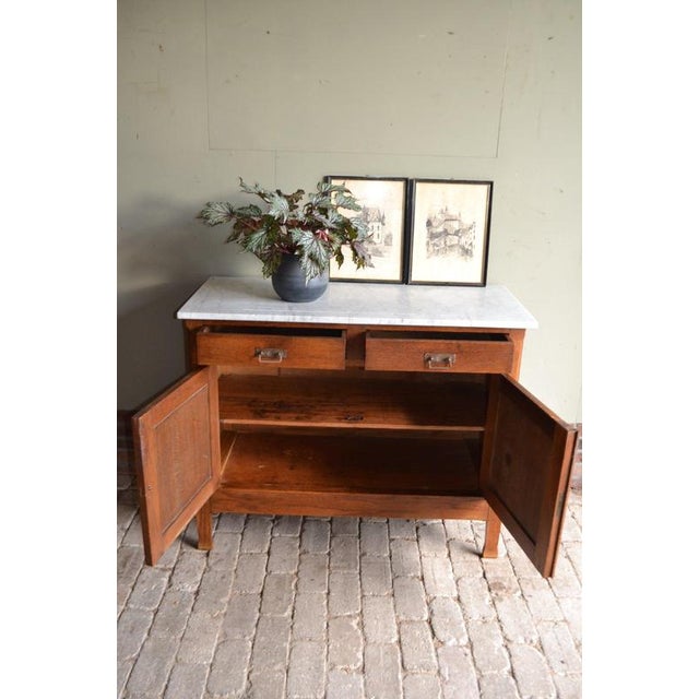 20th-century Dutch oak Art Deco girls' cabinet. The height is 87 cm. The width is 110 cm. The depth is 50 cm. with a white...