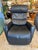 Design Plus Gallery presents a Power Swivel Recliner from Fjords. This black leather recliner has padded arms, a channel-...