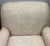 Elegant matching pair of generously proportioned armchairs upholstered in a soft cream damask fabric. Each chair features...