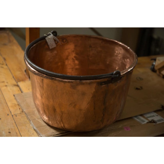 :: Antique hammered copper kettle with blacksmithed handle, most commonly used to make apple butter, likely from the mid...