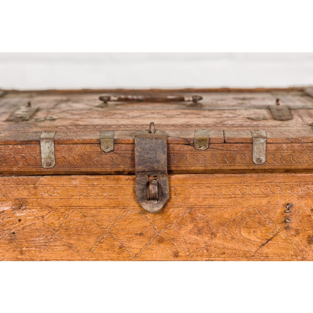 An antique Indian wooden document box from the 19th century with incised diamond motifs and wave patterns and partitioned...