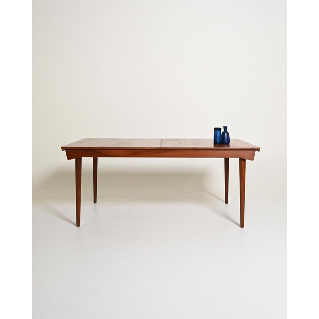 Teak dining table with tapered legs and two 50 cm extension leaves. Designed by finn juhl, with the "fd" mark from france...