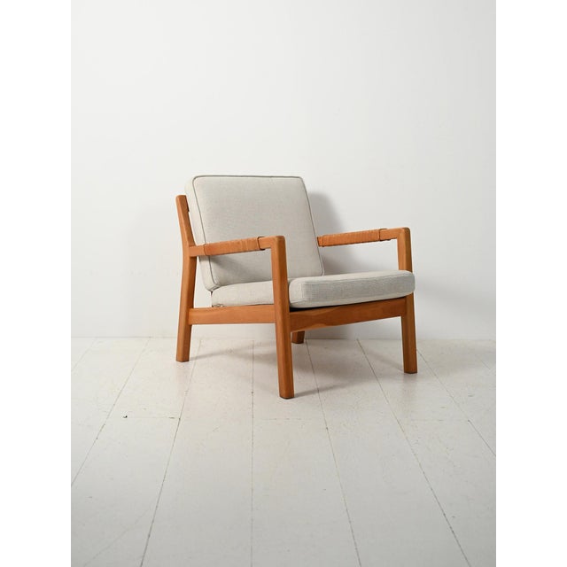 Rare Scandinavian armchair in solid oak with leather inserts on the armrests and a woven leather backrest. Rare...