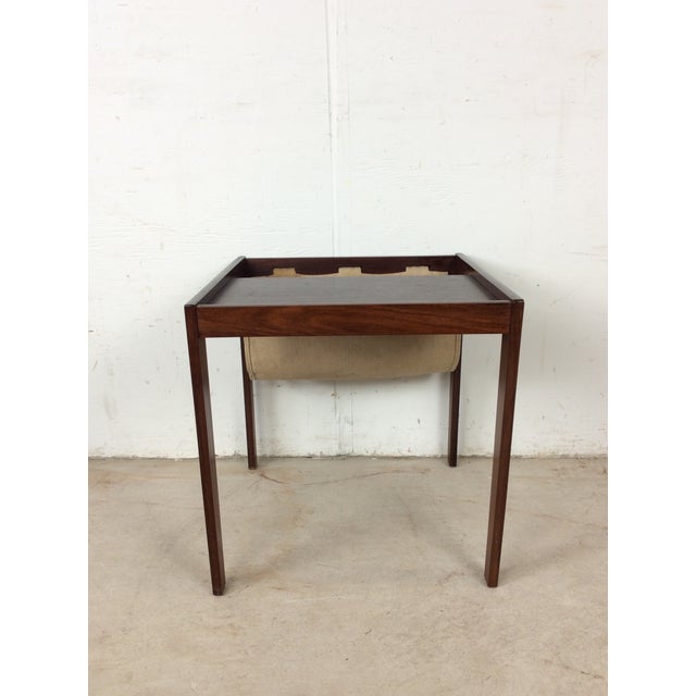 This Danish modern end table features hardwood construction, rosewood veneer with original finish, canvas sling for...
